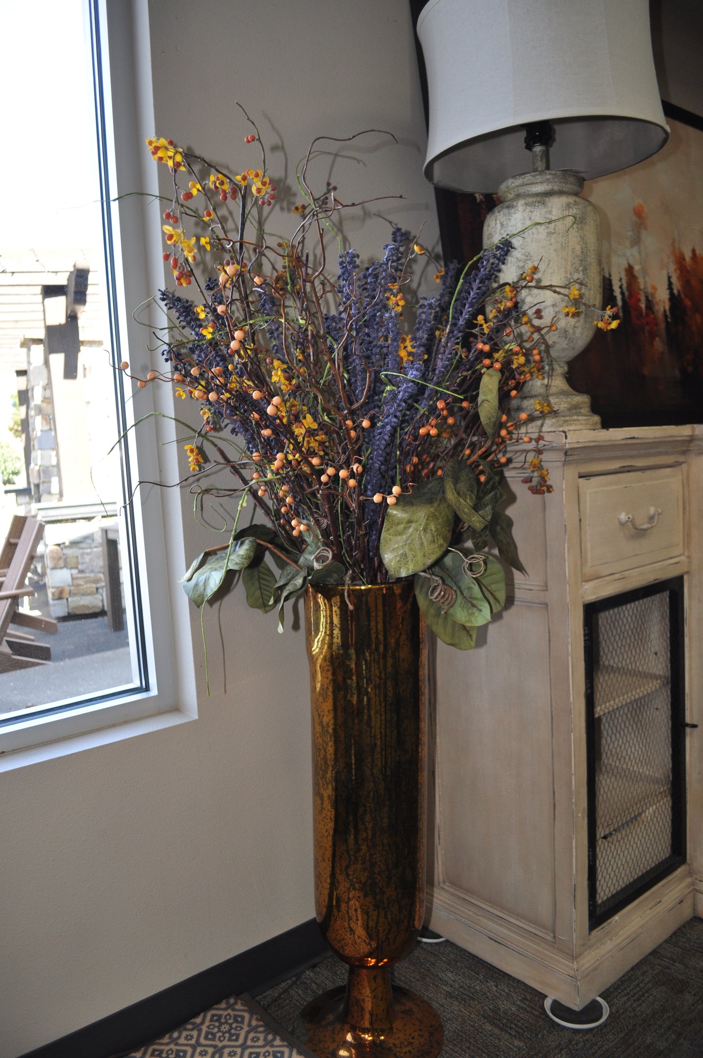 Tall Amber Vase with Purple and Bitter Sweet Floral Arrangement